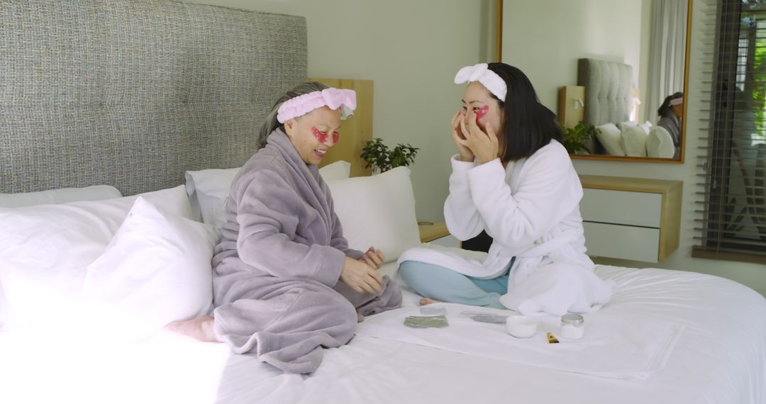 Mother and Daughter Bonding with Skincare in Bright Bedroom