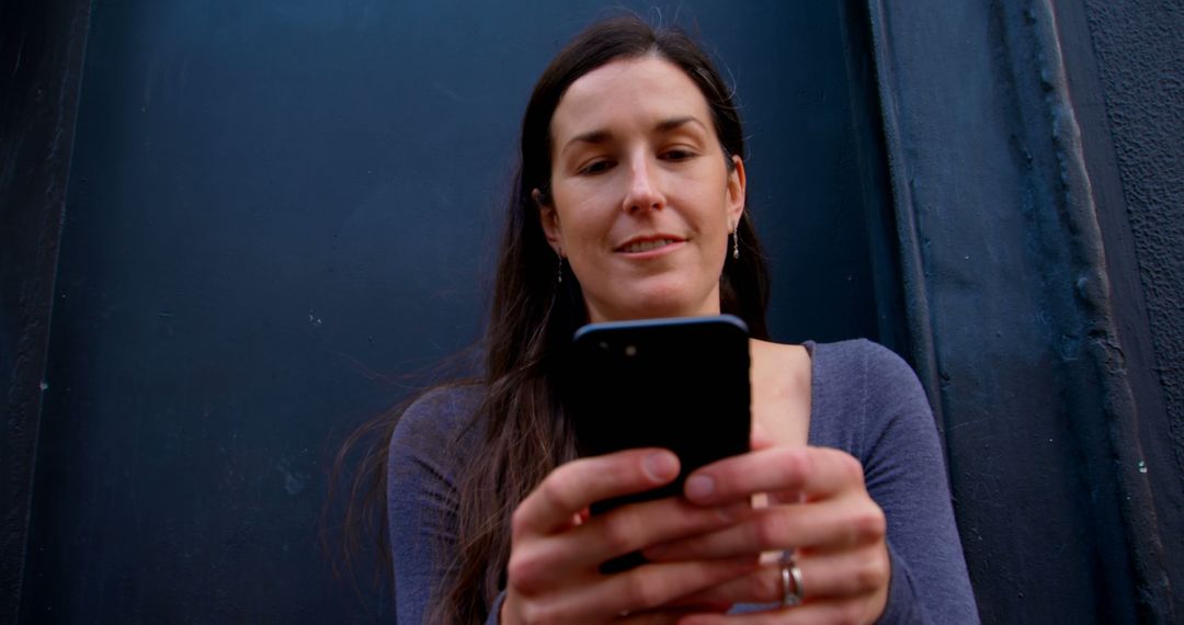 Woman Using Smartphone in Dark Urban Alley - Free Images, Stock Photos and Pictures on Pikwizard.com