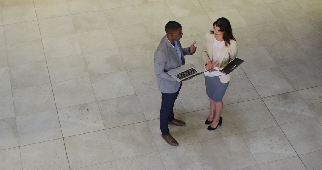 Business Professionals Discussing Project in Office Lobby