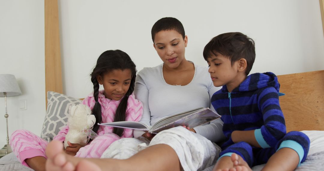 Mother Reading Storybook to Children in Pajamas - Free Images, Stock Photos and Pictures on Pikwizard.com