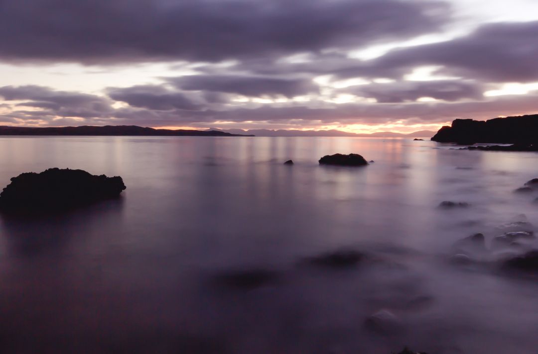 Serene Sunset Over Rocky Shoreline with Calm Waters - Free Images, Stock Photos and Pictures on Pikwizard.com