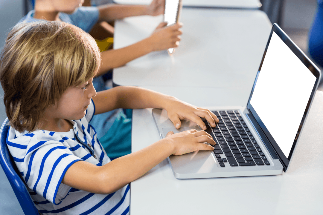 Cute Boy Engaging with Transparent Laptop in Classroom