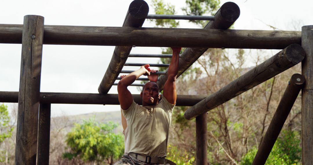 Determined Man Climbing Monkey Bars in Outdoor Military Obstacle Course - Free Images, Stock Photos and Pictures on Pikwizard.com