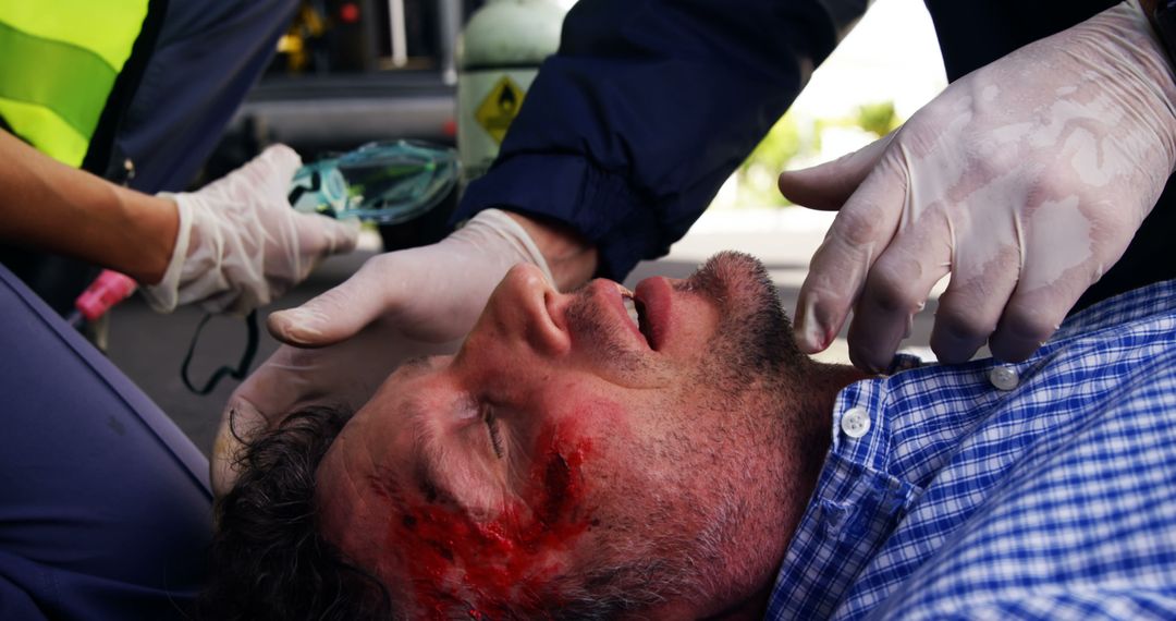 Emergency Medical Treatment for Injured Man with Head Wound - Free Images, Stock Photos and Pictures on Pikwizard.com