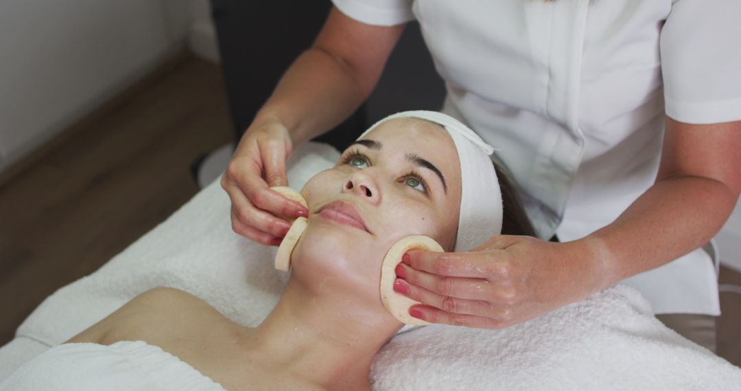 Caucasian Woman Receiving Relaxing Facial Treatment at Beauty Salon - Free Images, Stock Photos and Pictures on Pikwizard.com