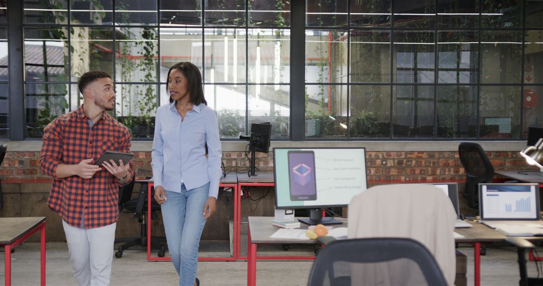 Diverse Colleagues Collaborating and Chatting in Office Environment