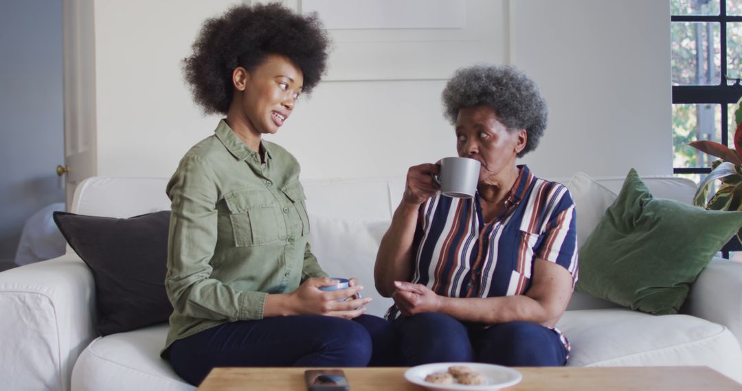 Mother and Daughter Sharing Coffee and Conversation at Home