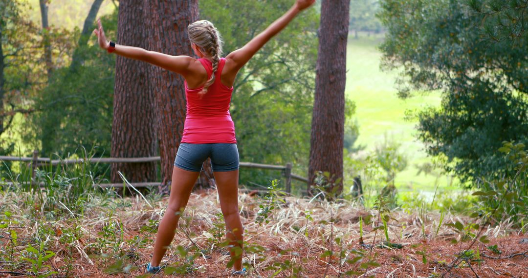 Woman Exercising Outdoors in Forest, Arms Outstretched - Free Images, Stock Photos and Pictures on Pikwizard.com