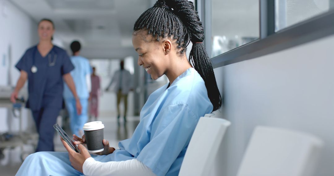 Smiling Female Nurse Relaxing on Break with Coffee and Digital Tablet in Hospital - Free Images, Stock Photos and Pictures on Pikwizard.com