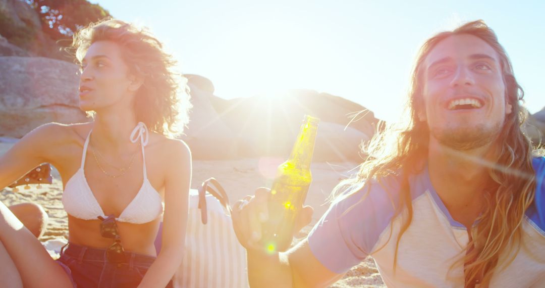 Young couple enjoying beach sunset with drinks - Free Images, Stock Photos and Pictures on Pikwizard.com