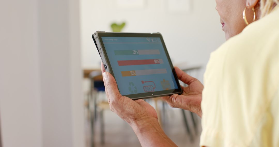 Senior Woman Checking Home Energy Use on Tablet