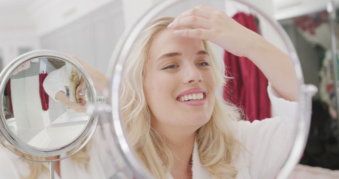 Blonde Woman Perfecting Makeup in Front of Mirror - Free Images, Stock Photos and Pictures on Pikwizard.com