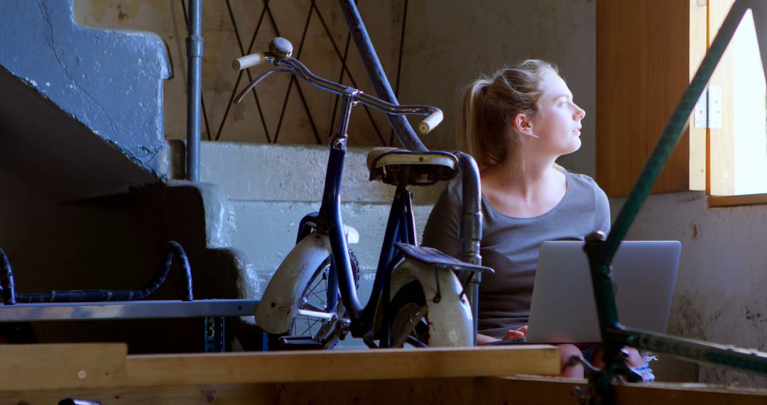 Young Woman Working on Laptop in Retro Styled Loft - Free Images, Stock Photos and Pictures on Pikwizard.com