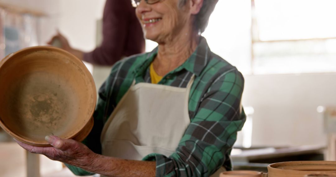 Senior Woman Glazing Clay Pot in Ceramics Workshop - Free Images, Stock Photos and Pictures on Pikwizard.com