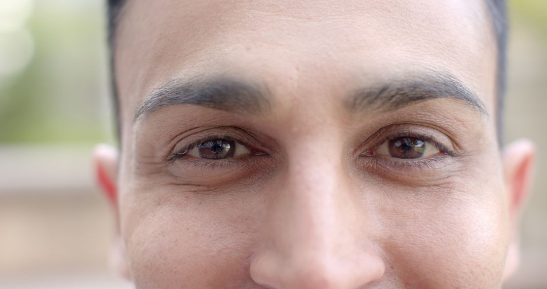 Close-Up of Biracial Man's Smiling Eyes in Sunny Garden - Free Images, Stock Photos and Pictures on Pikwizard.com