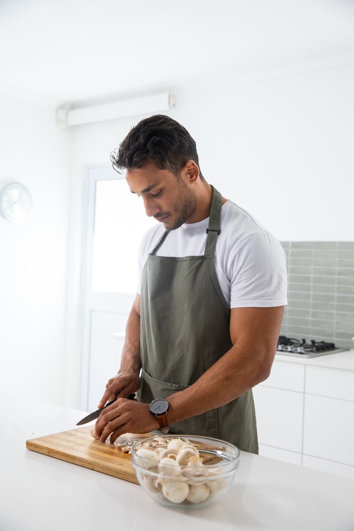 Man Preparing Mushrooms in Modern Home Kitchen
