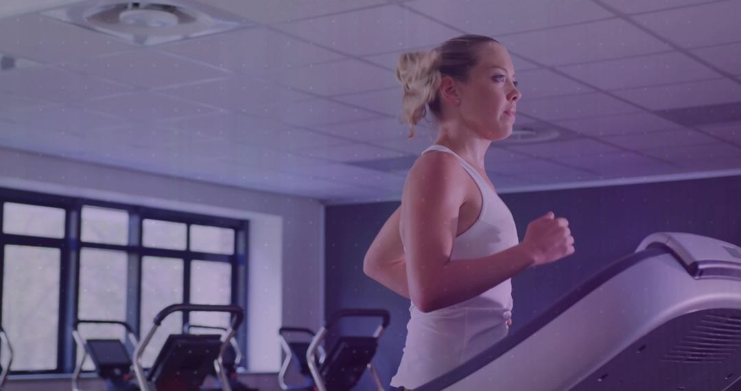 Determined Woman Running on Treadmill in Modern Gym Environment