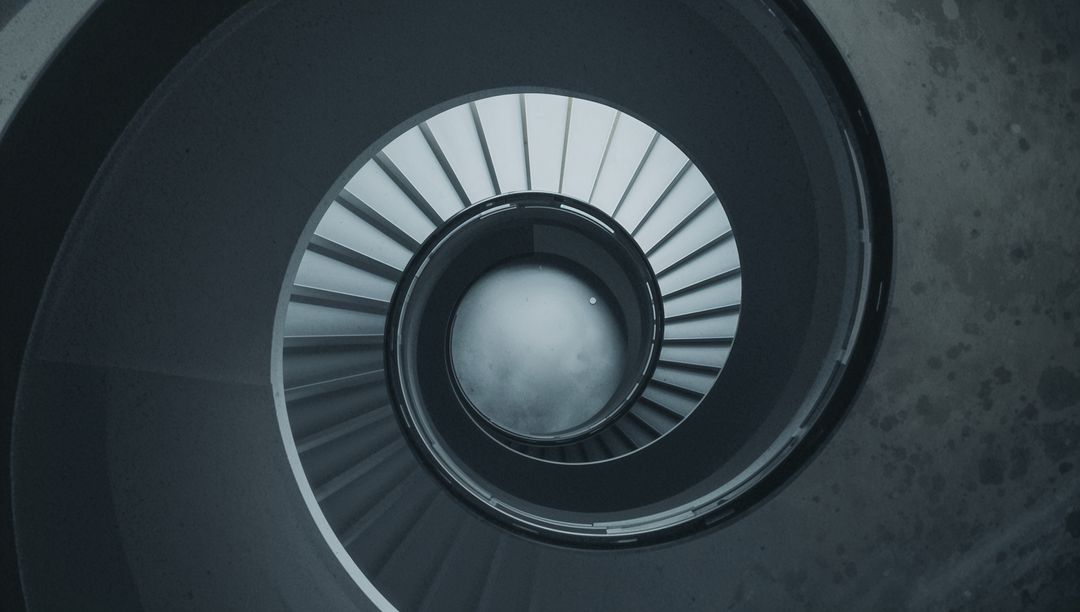 Abstract View of Concrete Spiral Staircase with Metal Handrail