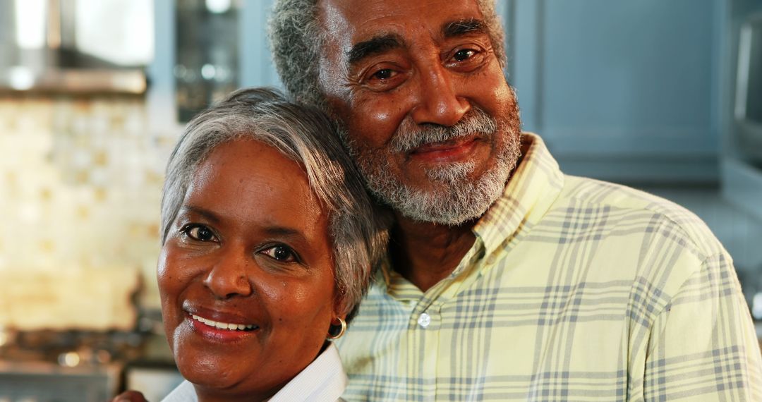 Smiling Senior Couple Embracing at Home Kitchen - Free Images, Stock Photos and Pictures on Pikwizard.com