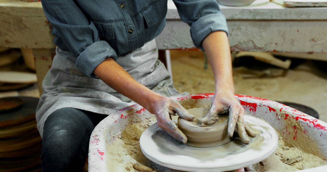 Hands Shaping Clay on Pottery Wheel in Artisan Workshop - Free Images, Stock Photos and Pictures on Pikwizard.com