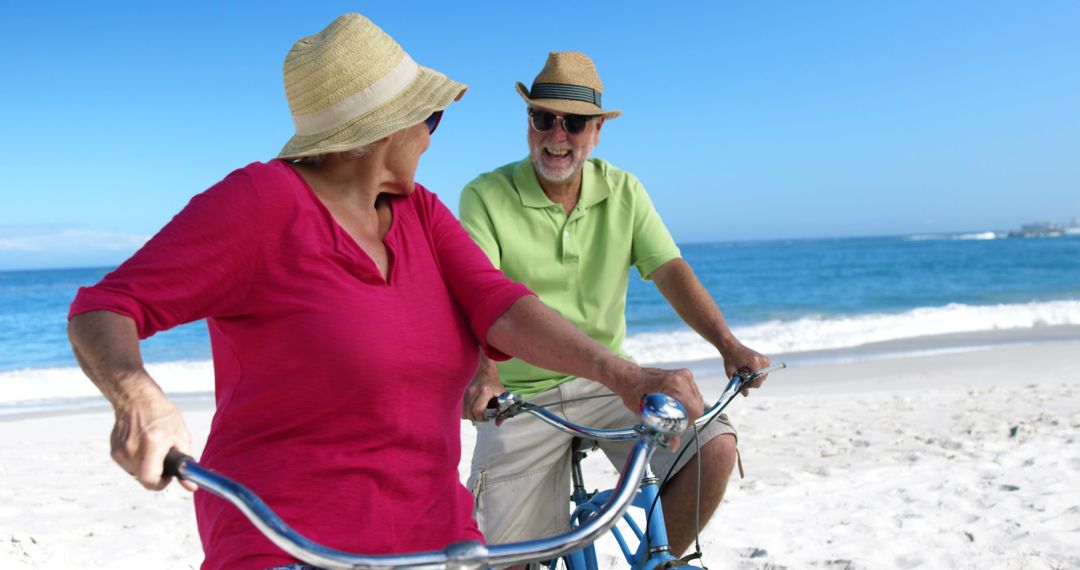 Happy Senior Couple Biking on Beach - Free Images, Stock Photos and Pictures on Pikwizard.com