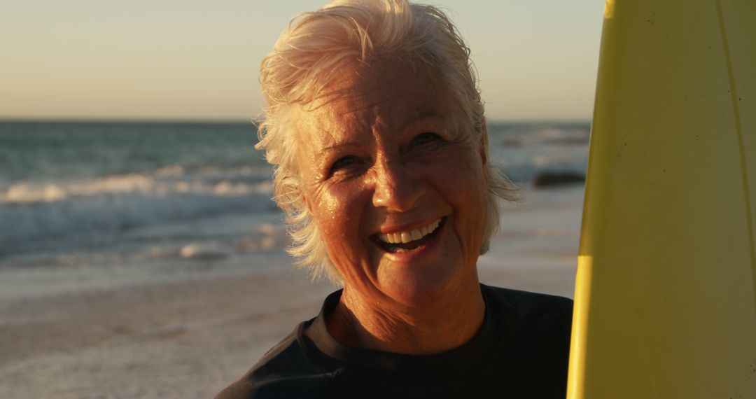 Senior Woman Enjoying Surfing at Beach During Sunset - Free Images, Stock Photos and Pictures on Pikwizard.com