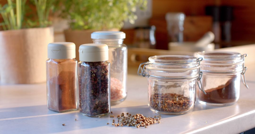 Various Spices in Glass Jars in a Bright Kitchen - Free Images, Stock Photos and Pictures on Pikwizard.com