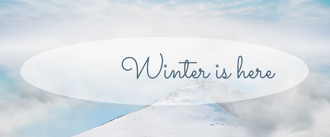 Serene Winter Landscape with Snowy Mountains and Soft Clouds