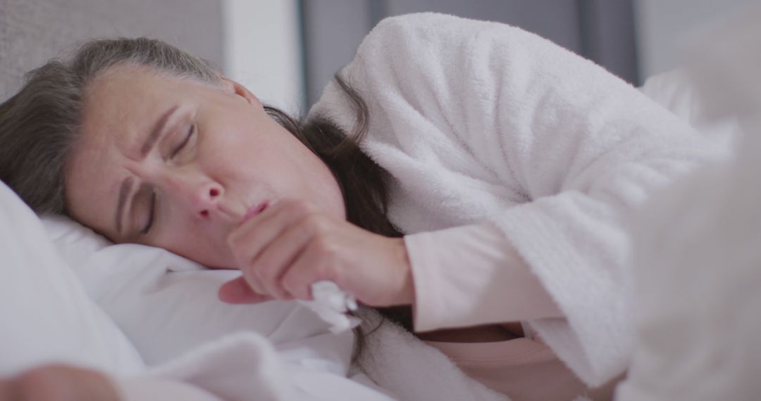 Elderly Woman Coughing in Bed While Resting - Free Images, Stock Photos and Pictures on Pikwizard.com