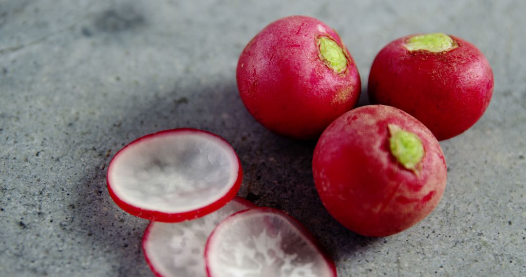 Fresh Red Radishes with Slices on Concrete Background - Free Images, Stock Photos and Pictures on Pikwizard.com