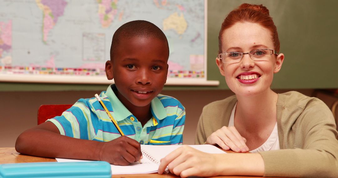 Smiling Teacher Helping Student With Homework in Classroom - Free Images, Stock Photos and Pictures on Pikwizard.com