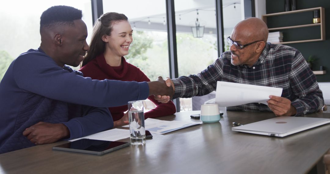 Happy Couple Receiving Financial Advice from Advisor