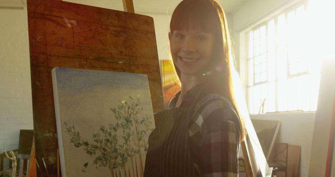 Female Artist Painting on Canvas in Sunlit Studio - Free Images, Stock Photos and Pictures on Pikwizard.com