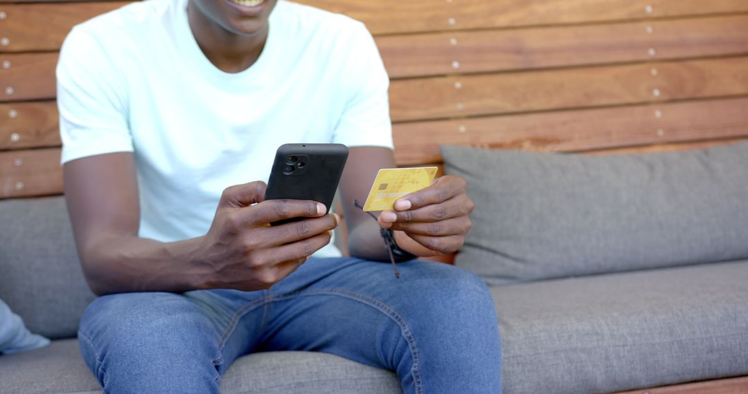 Online Shopping, Man with Smartphone and Credit Card at Home