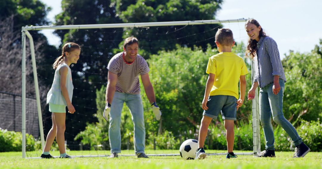 Family Playing Soccer Outdoors in Sunny Park - Free Images, Stock Photos and Pictures on Pikwizard.com