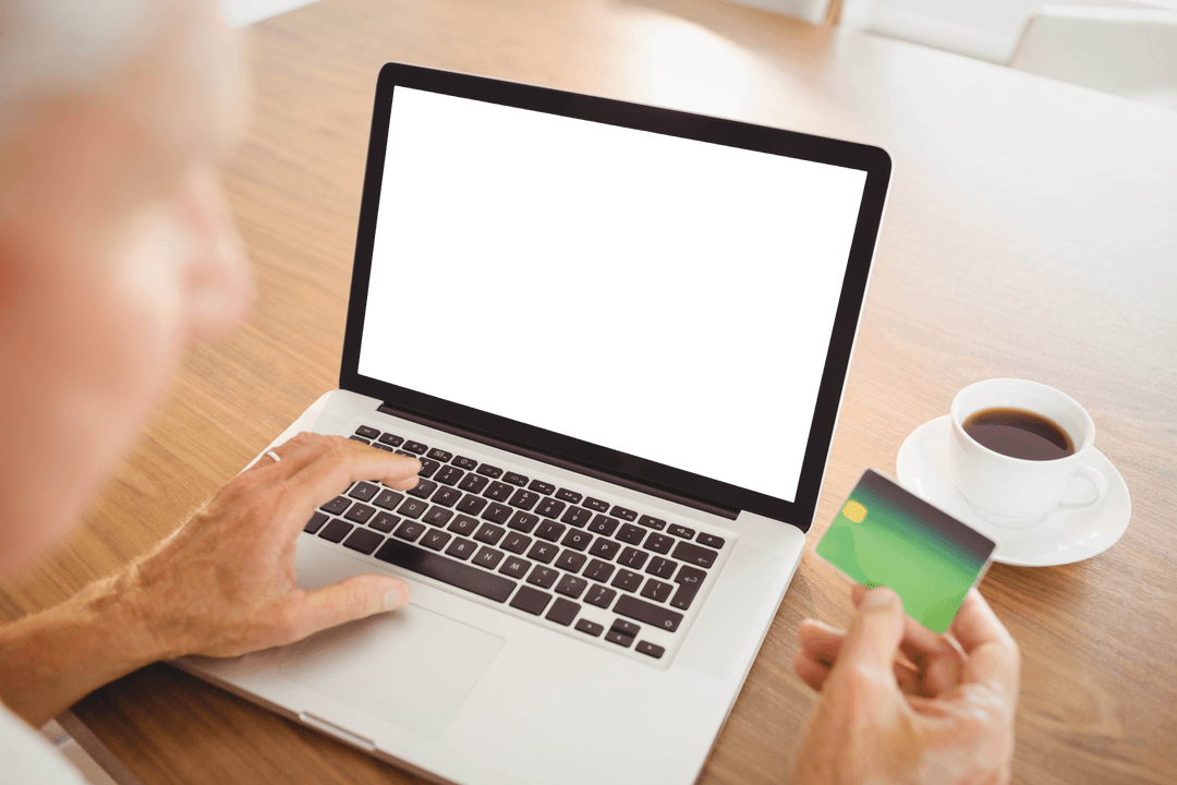Elderly Man Making Online Purchase on Laptop with Credit Card
