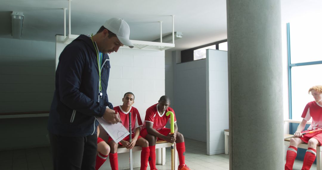 Soccer Coach Talking to Reflective Players in Locker Room - Free Images, Stock Photos and Pictures on Pikwizard.com