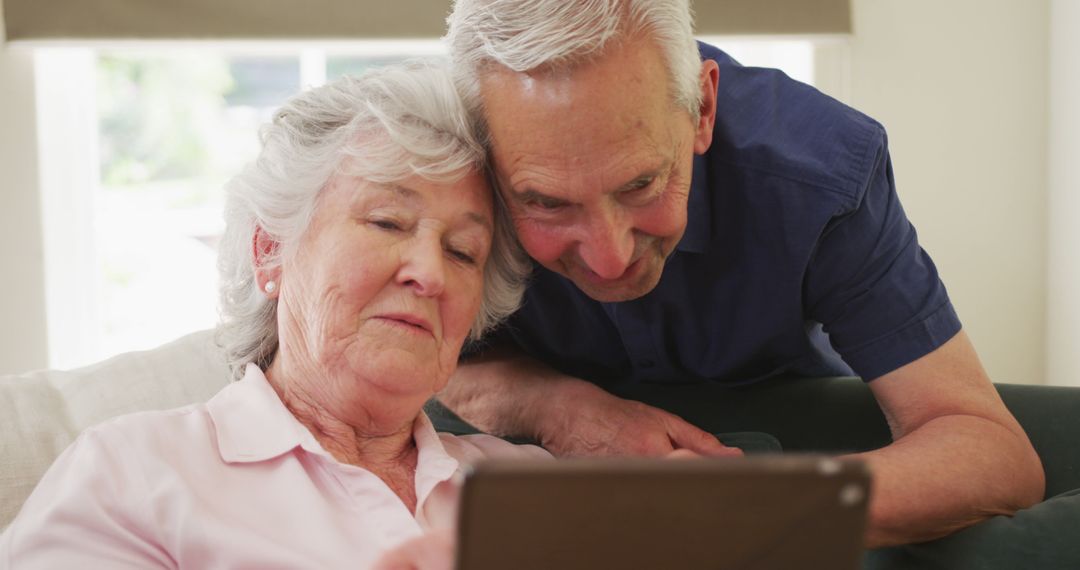 Senior Couple Using Digital Tablet at Home - Free Images, Stock Photos and Pictures on Pikwizard.com