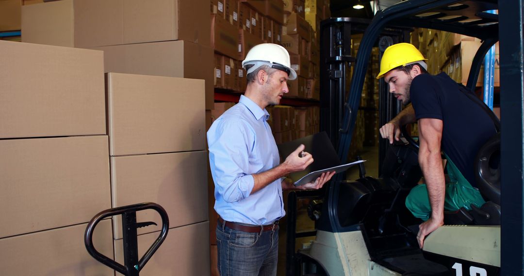 Warehouse Manager Instructing Forklift Operator on Loading Procedures - Free Images, Stock Photos and Pictures on Pikwizard.com