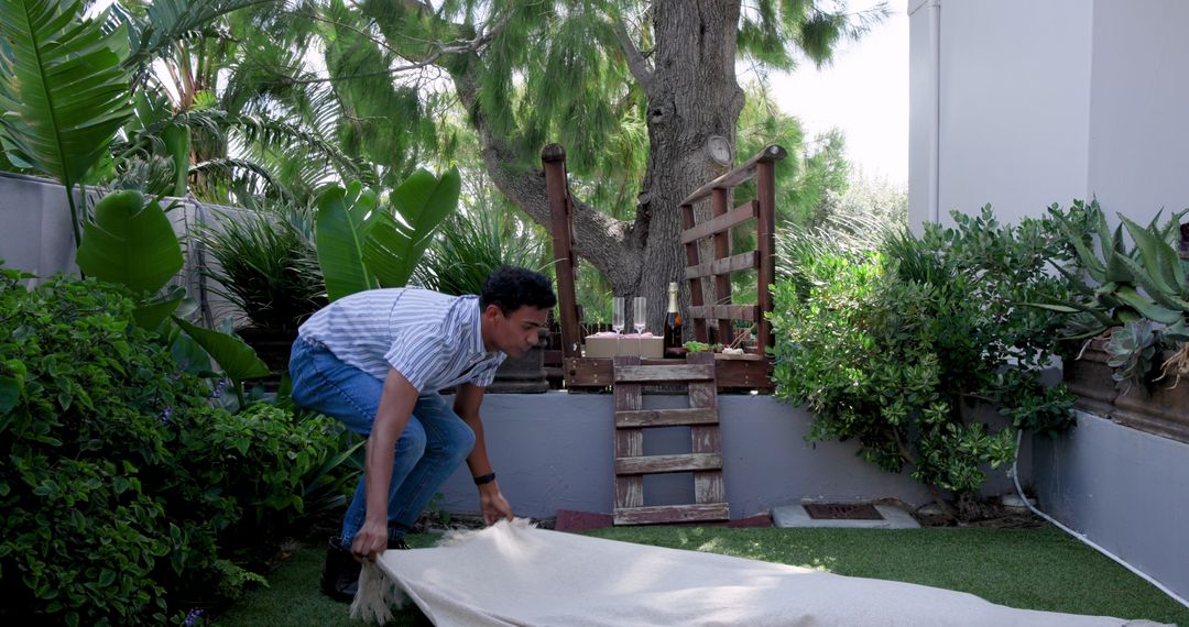 Man Preparing Indigenous Outdoor Picnic Spot with Wine Glasses