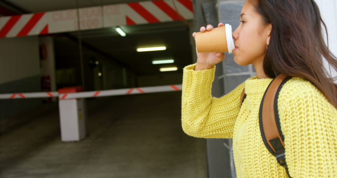 Young Woman Drinking Coffee Outdoors in Yellow Sweater - Free Images, Stock Photos and Pictures on Pikwizard.com