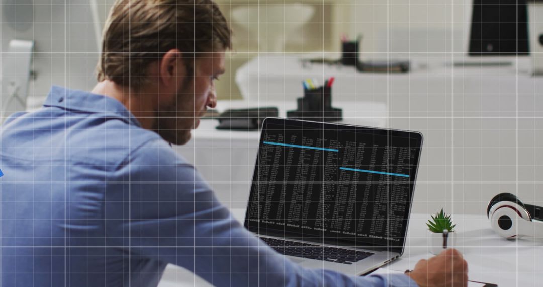 Caucasian Businessman Analyzing Data on Laptop at Office