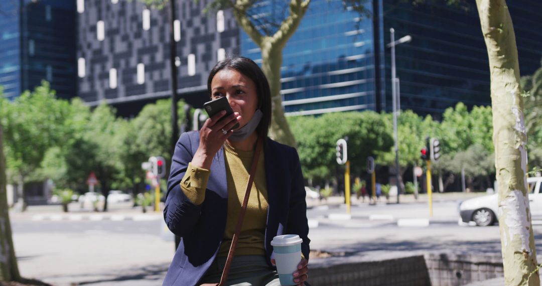 Businesswoman using smartphone and drinking coffee outdoors in urban area - Free Images, Stock Photos and Pictures on Pikwizard.com