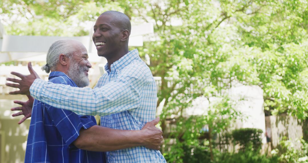 Happy African American Father and Son Hugging Outdoors - Free Images, Stock Photos and Pictures on Pikwizard.com