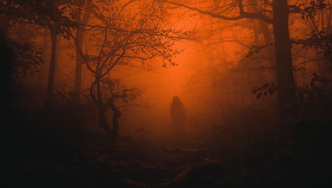 Mysterious Cloaked Figure in Enigmatic Orange Mist