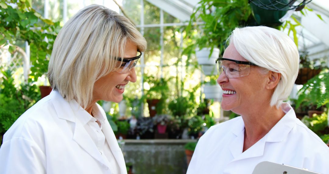 Two Female Scientists Smiling in Plant Research Laboratory - Free Images, Stock Photos and Pictures on Pikwizard.com