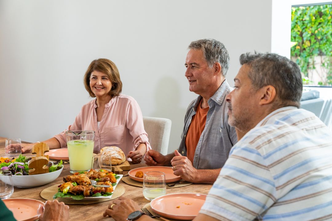 Senior Friends Gathering for Meal Sharing Experiences and Laughter