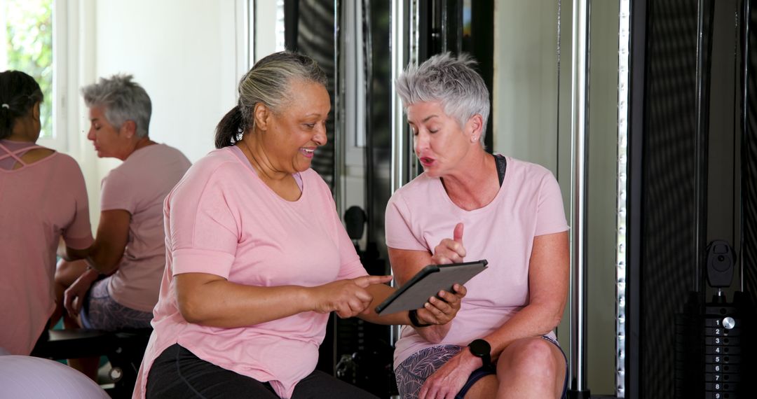 Active Senior Couple Using Tablet in Home Gym