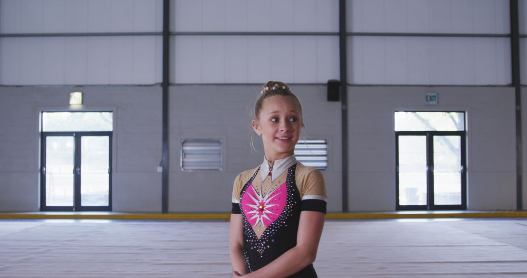 Smiling Young Gymnast Standing in Large Sports Hall - Free Images, Stock Photos and Pictures on Pikwizard.com