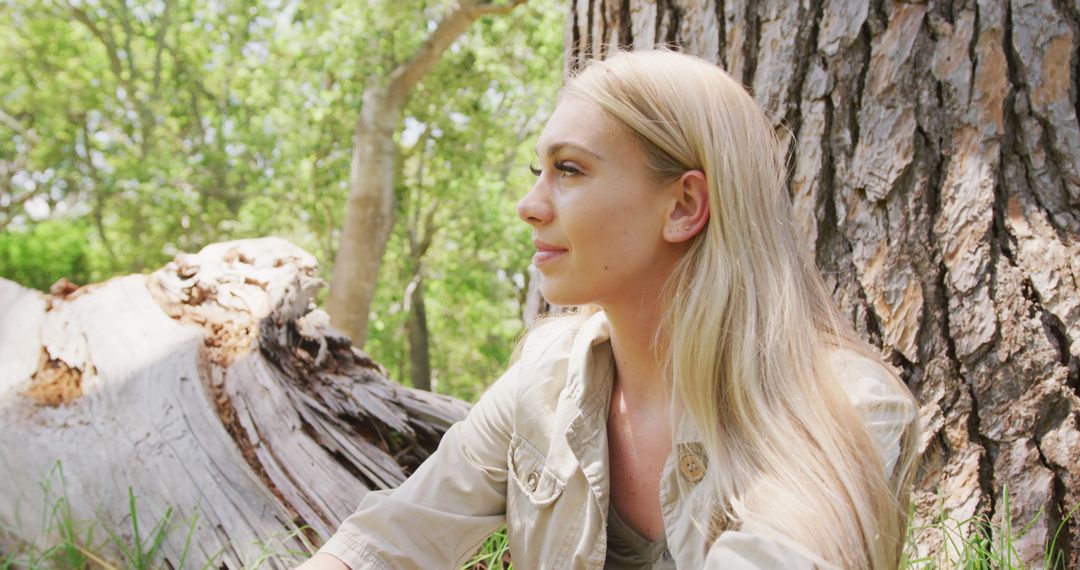 Pensive Young Blonde Woman Relaxing By Tree Outdoors - Free Images, Stock Photos and Pictures on Pikwizard.com